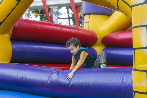 handsome boy playing in bouncy castle