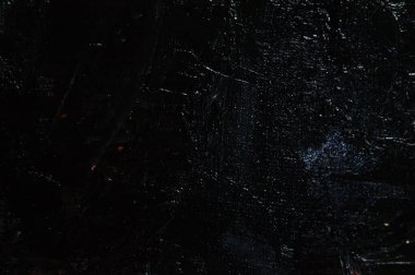 Karanlık yaratıcı arka plan, pürüzlü keten branda siyah astar ile örtülü, ışığın yansımaları. Tonlama, bulanıklaştırma, seçici odaklanma. 