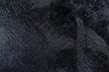 Karanlık yaratıcı arka plan, pürüzlü keten branda siyah astar ile örtülü, ışığın yansımaları. Tonlama, bulanıklaştırma, seçici odaklanma. 