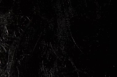 Karanlık yaratıcı arka plan, pürüzlü keten branda siyah astar ile örtülü, ışığın yansımaları. Tonlama, bulanıklaştırma, seçici odaklanma. 