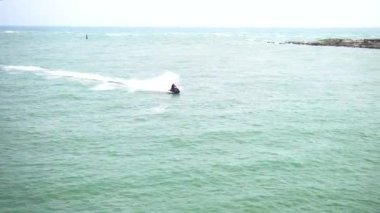Hava manzaralı jet ski açık sularda yarışıyor. Yazın jet ski ile eğlenen adam.