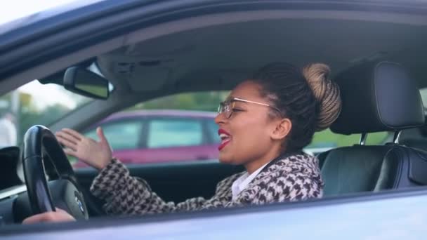 Krásná černoška sedí v autě a stěžuje si na dopravní situaci — Stock video