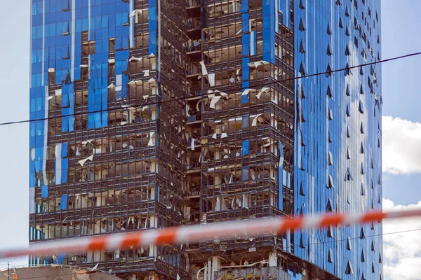 Rocket attack on the capital of Ukraine. Damaged business center building. Skyscraper after missle attack.