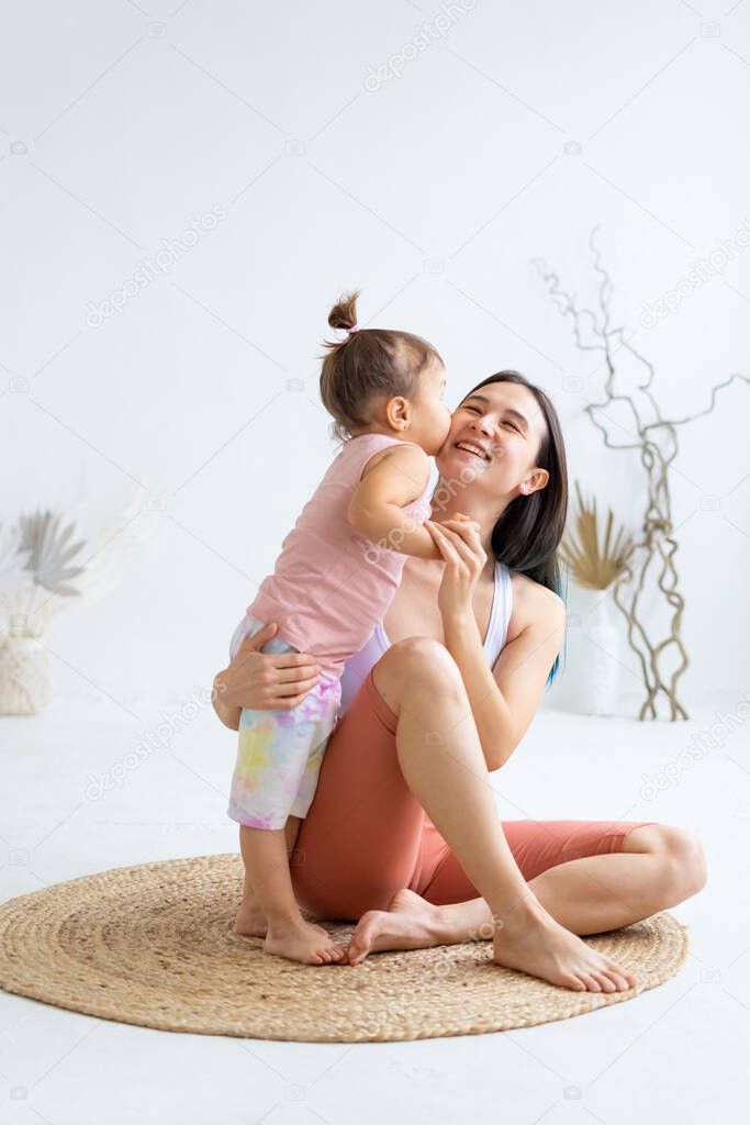 Little daughter kisses and hugs her mother. Love and motherly care.