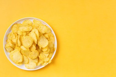 Sarı zemin üzerinde altın kırışıklık olan beyaz tabak ve fotokopi alanı. 2021 yılının renkleri. Üst görünüm.