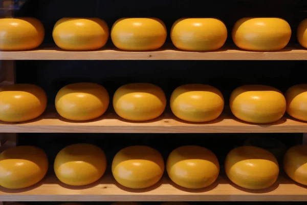 Ronds of dutch cheese on shelves