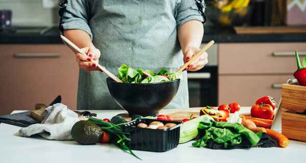 Close Up Photo of Woman Hands Making Fresh Salad At Home