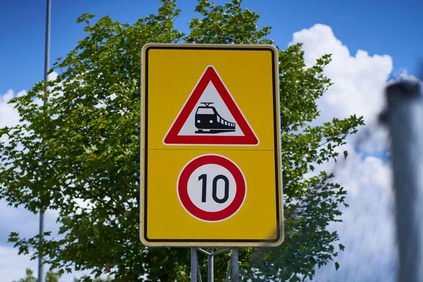 The traffic sign means unrestricted train crossing. The speed limit is 10. Beware of the unrestricted tram crossing. Trains and trams have priority.                               