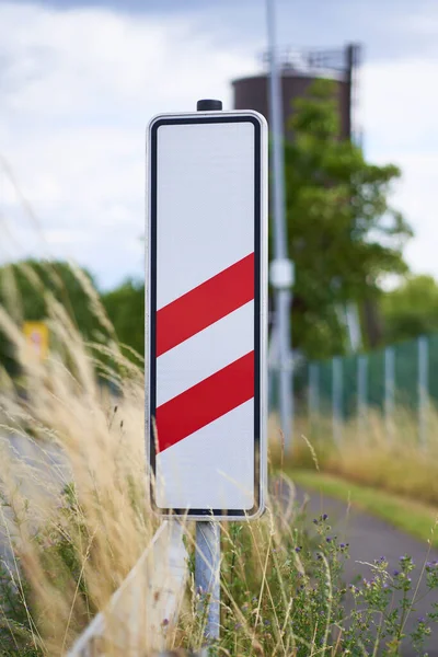 The sign indicates that the train crossing is still 160 meters away. The red stripes are for 160 meters. Beware of trams or trains.                             