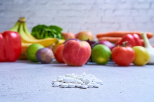 Pills vs vegetables and fruits. Nutrition as medicine. Eating style affects health. Many people also take dietary supplements as a source of vitamins.