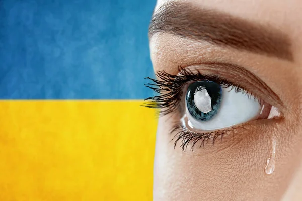 Ukraine crisis concept. Eye, crying with a tear running down her cheek