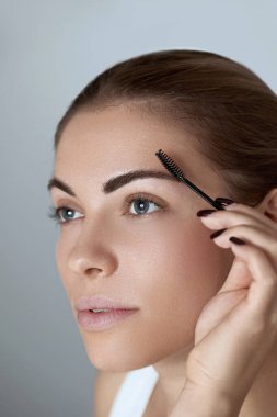 Eyebrows correction. Shape. Beautiful young woman with perfect natural eyebrows and eyelashes.  Natural make up. Beauty. Eyebrows and eyelashes