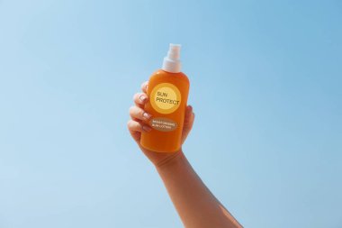 Woman Holding Suntan Lotion And Moisturizing Sunblock. Skin And Body Care. Girl Using Sunscreen To Skin