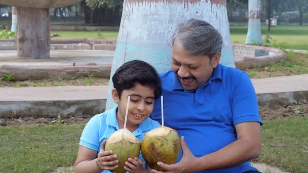 Old Man Little Boy Enjoying While Drinking Tender Coconut Water — Stockvideo