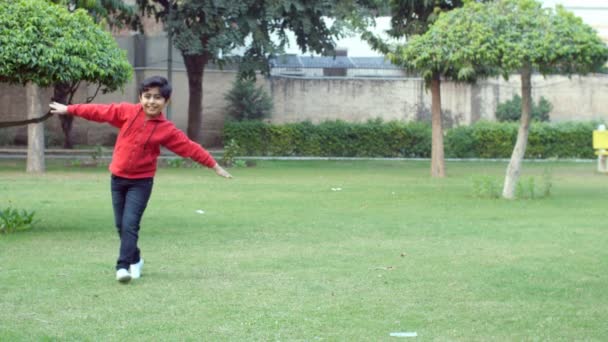 Carefree Child Happily Running Park Both His Arms Wide Open — стоковое видео