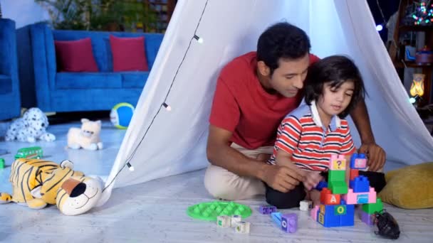 Happy Dad His Little Son Constructing Building Using Colorful Blocks — Stock Video