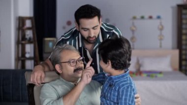 Sevimli bir çocuk, babası ve büyükbabasıyla mutlu bir aile, Hintli bir aile ile vakit geçiriyor. Üç nesildir aile üyeleri oturma odasında birlikte oturuyorlar. İlişki ve bağ kurma, boş zaman.