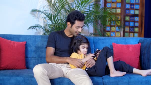 Affectionate Indian Father His Little Son Sitting Together Couch Single — Stock Video
