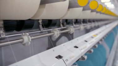 Tekstil fabrikasında çalışan makinelerin yakın çekimi.. 