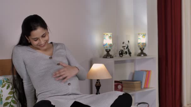 Μια Νεαρή Έγκυος Γυναίκα Τρίβει Στομάχι Της Ενώ Μιλάει Στο — Αρχείο Βίντεο