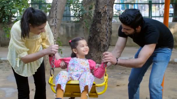 Married Indian Couple Daughter Sitting Swing Family Bonding Happy Childhood Stock Video