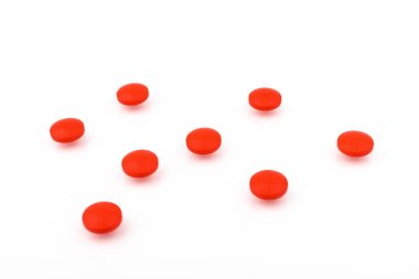 Beyaz arka planda kırmızı haplar var. Tıp konsepti