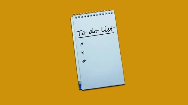 Hand writing note to do list on a notebook. lifestyle, advice, support motivational positive words are written on a wooden background. Business, signs, symbols, concepts. Copy space.