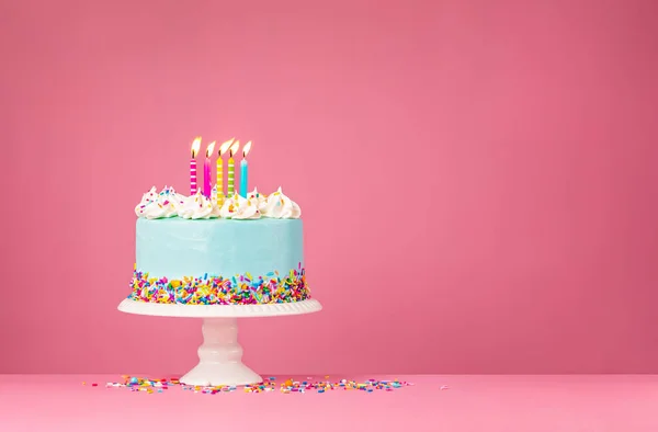 Torta di compleanno blu con cinque candele su sfondo rosa — Foto Stock