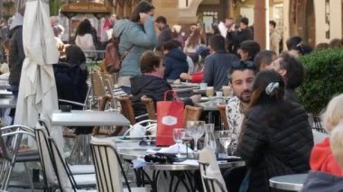 10 Ekim 2021 - Strasbourg, Fransa: İnsanlar kentin merkez meydanındaki kafeteryalarda covid-19 'a karşı koruyucu tıbbi maske takmadan oturuyorlar. Coronavirüs salgınından sonra aşı pasaportlarıyla giriş