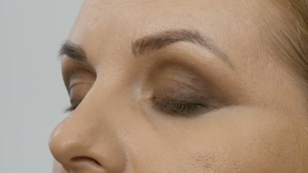 Professionnel jaune brun beige maquillage soirée yeux fumés. Maquillage des yeux, vue rapprochée du visage. Concept cosmétique. — Video