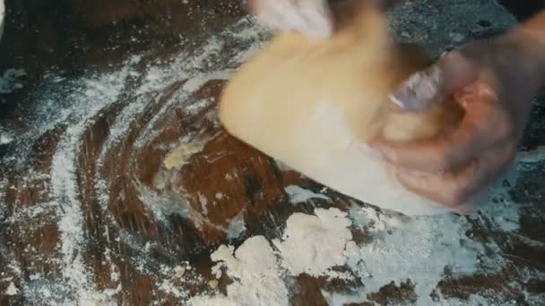 Female hands knead fresh homemade dough on a special kitchen board in the home kitchen. Home baking pastries — Stock Video
