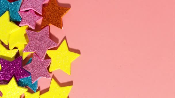 Stop motion animation of wooden letters with the word party add up. Festive multicolored stars on a gentle coral background — Stock Video
