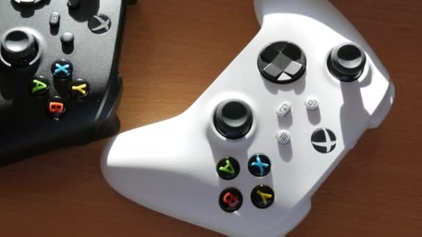 9 décembre 2021 - Kehl, Allemagne : Deux joysticks en noir et blanc sur la table devant la console de jeux White Microsoft Xbox Series S Game Controller, La plus récente manette de jeu sans fil, joysticks pour — Video