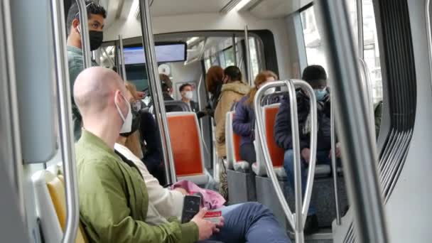 STRASBOURG, FRANCE - MAY 23, 2021: People ride on a city tram or train wearing protective masks against the pandemic, covid 19 sars — Vídeos de Stock