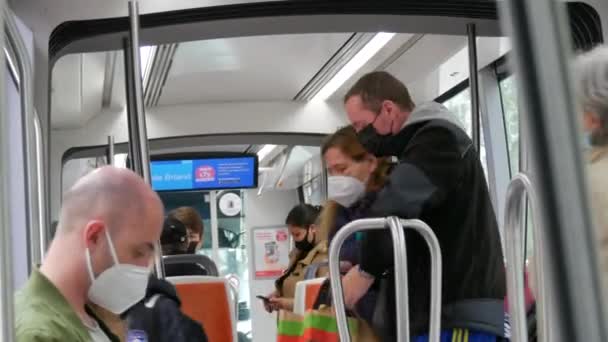 STRASBOURG, FRANCE - MAY 23, 2021: People ride on a city tram or train wearing protective masks against the pandemic, covid 19 sars — ストック動画