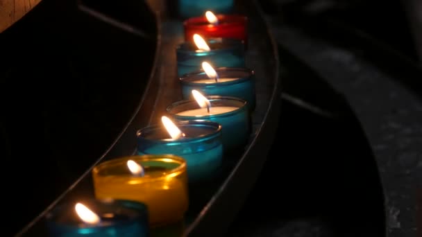 Row Flaming Multi Colored Church Candles Burning Temple Close View — Videoclip de stoc