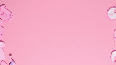 Funny pink stickers, symbolizing a newborn girl, appear on a pink background. Stop motion animation cartoon.