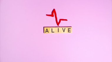 Plasticine stop motion animation. Wooden letters lay out the word time, a plasticine clock face appears and flickers against a purple background. Claymotion.