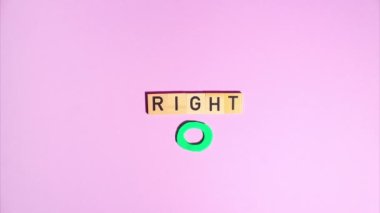 Plasticine stop motion animation. Wooden letters spell out the word correctly, a plasticine green circle appears and flickers on a purple background.