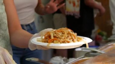 Asian noodles cooked at street food festival close up view.