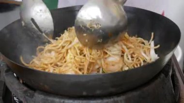 Asian noodles cooked at street food festival close up view.