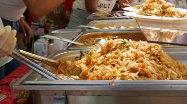 Asian noodles cooked at street food festival close up view.