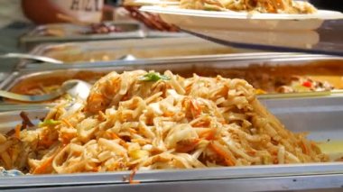 Asian noodles cooked at street food festival close up view.