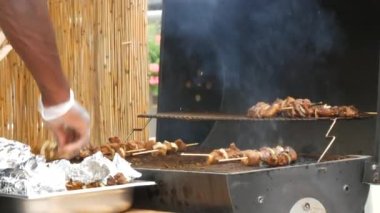Pieces of fresh meat are grilled on a grill at a street food festival. Non vegetarian food, meat eaters.