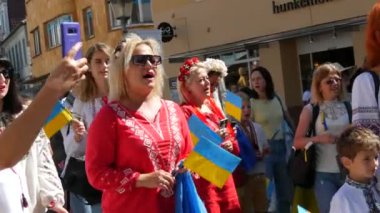 June 25, 2022 - Offenburg, Germany: Ukrainians in national costumes with embroidered shirts with Ukrainian symbols and flags in demonstration support of Ukraine against war with Russia.