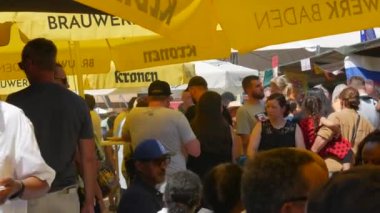 June 25, 2022 - Offenburg, Germany: A large number of people gathered at the street food festival, on a summer day. Vacationers eat, drink, want between the rows in search of interesting food.