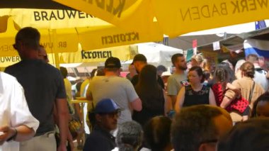 June 25, 2022 - Offenburg, Germany: A large number of people gathered at the street food festival, on a summer day. Vacationers eat, drink, want between the rows in search of interesting food.