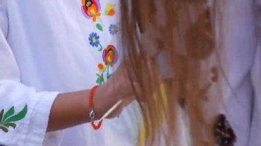 Blue-yellow flags of Ukrainians in the hands. People in national Ukrainian embroidered vyshyvanka costumes hold flags in their hands at a demonstration rally in support of Ukraine.