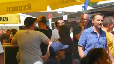 June 25, 2022 - Offenburg, Germany: A large number of people gathered at the street food festival, on a summer day. Vacationers eat, drink, want between the rows in search of interesting food.