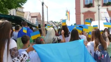 June 25, 2022 - Offenburg, Germany: Ukrainians in national costumes with embroidered shirts with Ukrainian symbols and flags in demonstration support of Ukraine against war with Russia.